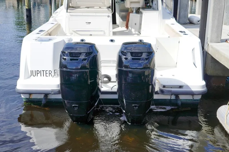 Slide: The Image of 2015 Boston Whaler 315 Conquest with dual outboard engines, docked in Jupiter, FL. - 19