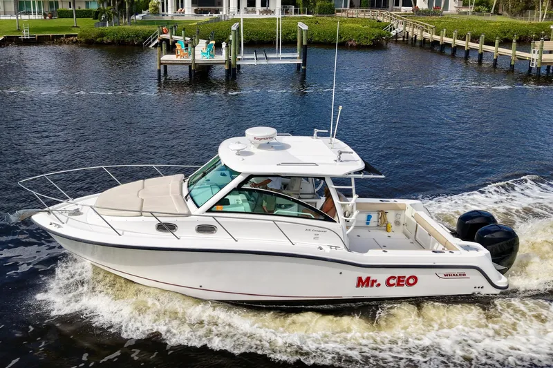 Slide: The Image of 2015 Boston Whaler 315 Conquest boat cruising on a river. - 23