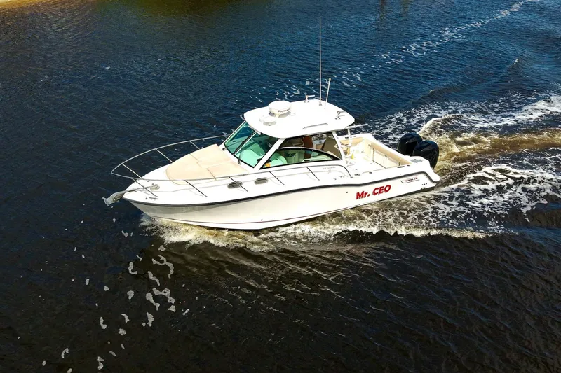 Slide: The Image of 2015 Boston Whaler 315 Conquest boat cruising on water, labeled "Mr. CEO." - 26