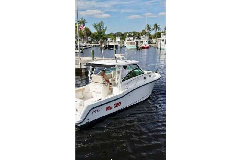 Slide: The Image of 2015 Boston Whaler 315 Conquest boat named "Mr. CEO" docked in a marina. - 28