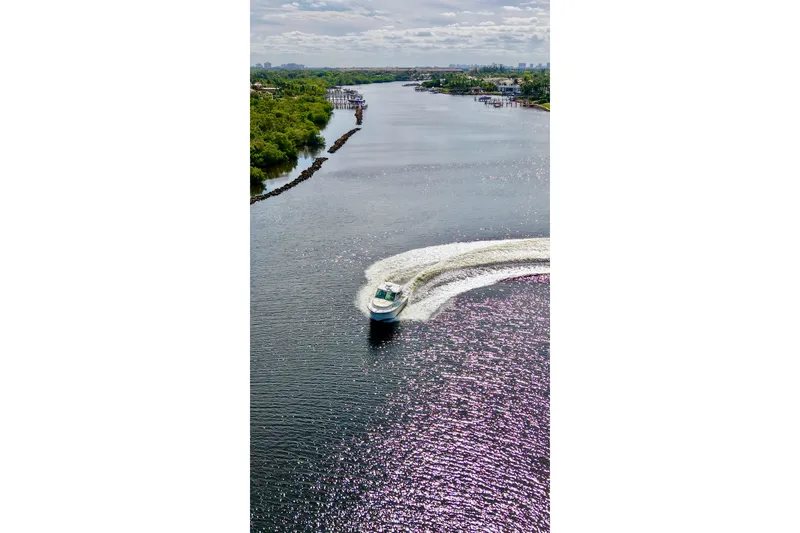 Slide: The Image of Aerial view of 2015 Boston Whaler 315 Conquest cruising on a scenic river. - 29