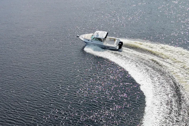 Slide: The Image of Aerial view of 2015 Boston Whaler 315 Conquest making a sharp turn on water. - 3