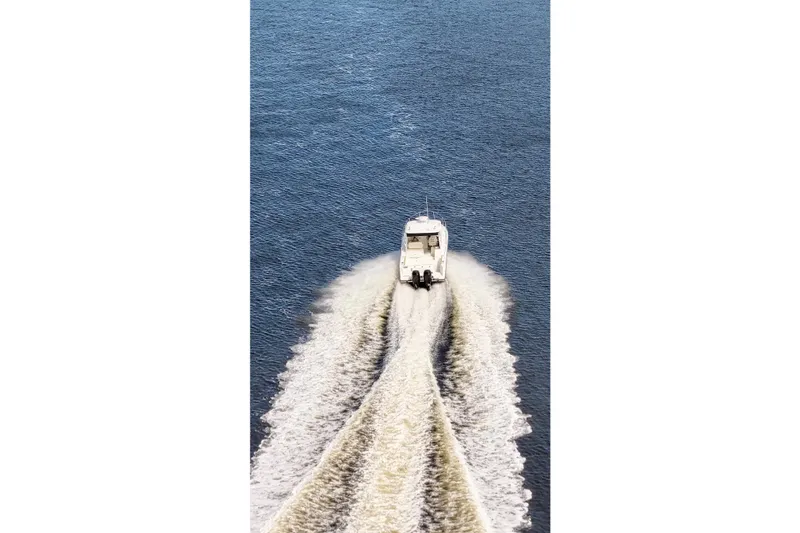 Slide: The Image of 2015 Boston Whaler 315 Conquest cruising on open water, leaving a wake trail. - 32