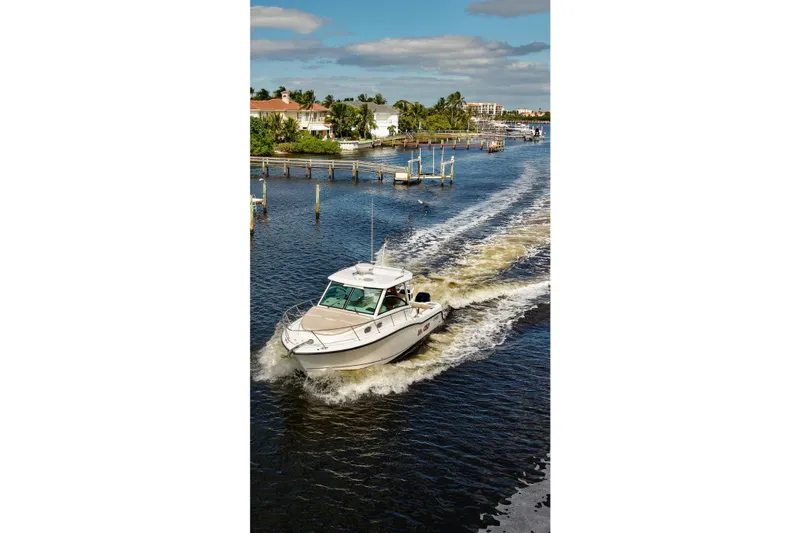 Slide: The Image of 2015 Boston Whaler 315 Conquest cruising on a scenic waterway. - 34