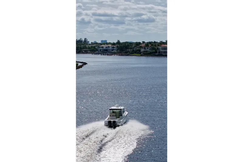 Slide: The Image of 2015 Boston Whaler 315 Conquest cruising on a scenic waterway. - 35
