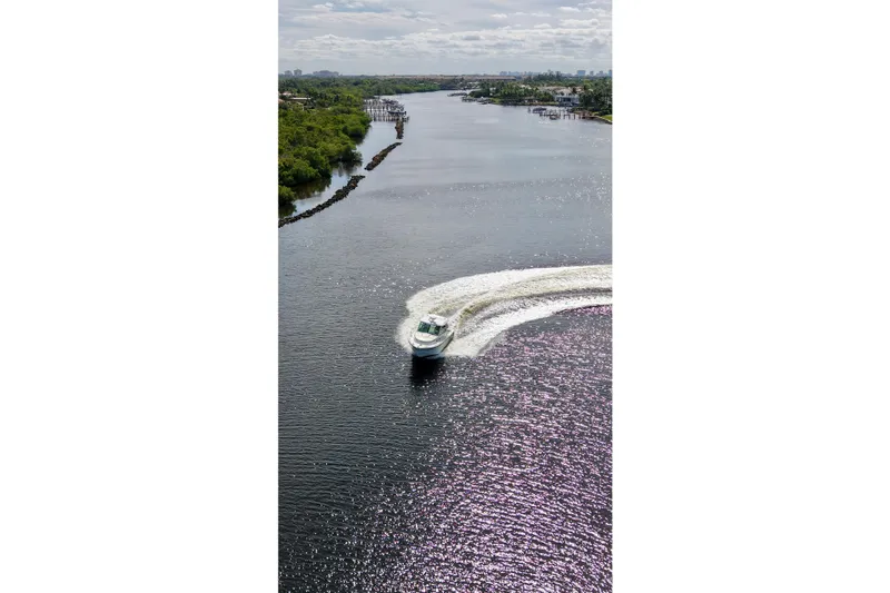Slide: The Image of Aerial view of 2015 Boston Whaler 315 Conquest cruising on a scenic river. - 37