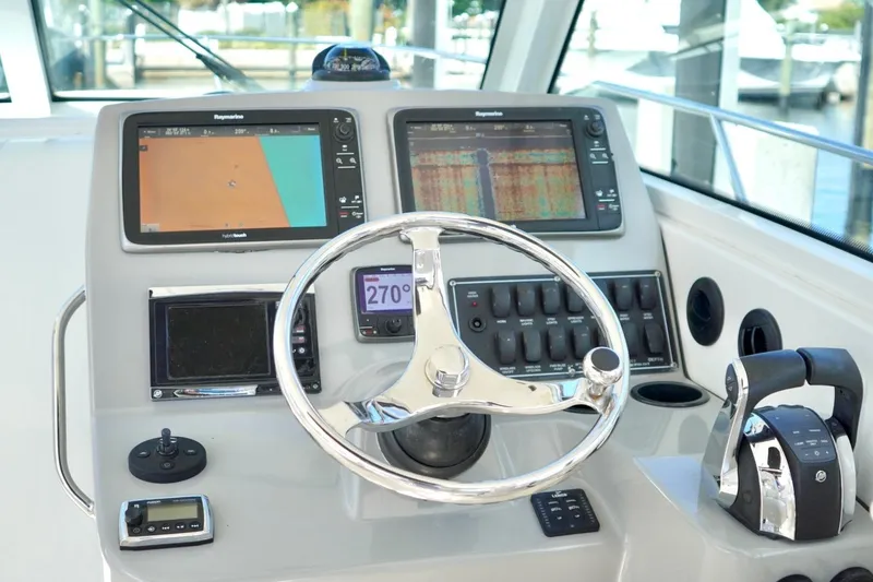 Slide: The Image of Control panel of a 2015 Boston Whaler 315 Conquest boat with navigation screens. - 5