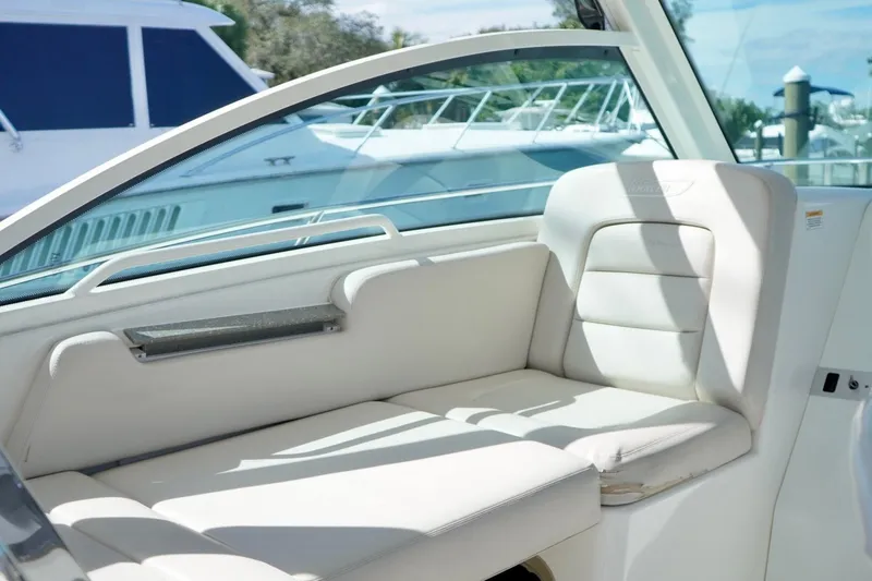 Slide: The Image of 2015 Boston Whaler 315 Conquest interior seating with white upholstery. - 6