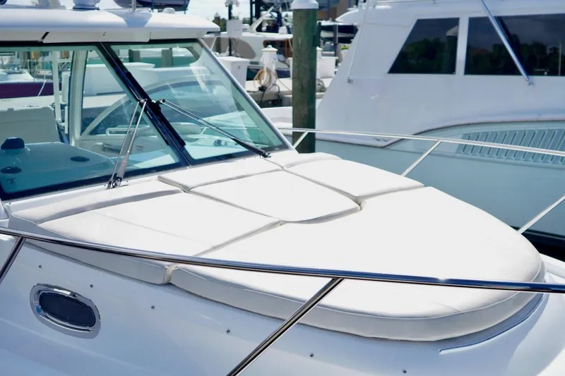 Slide: The Image of 2015 Boston Whaler 315 Conquest boat docked, featuring sleek design and spacious deck. - 7