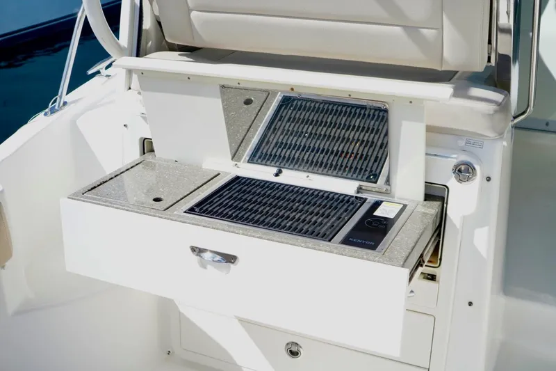 Slide: The Image of 2015 Boston Whaler 315 Conquest boat grill and countertop detail. - 8