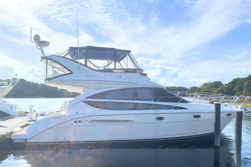 The Image of 2007 Meridian 391 Sedan yacht cruising on open ocean under clear blue sky. - 0