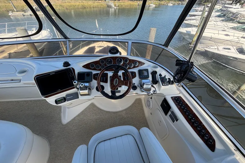 Slide: The Image of 2007 Meridian 391 Sedan helm with steering wheel, controls, and navigation equipment. - 10
