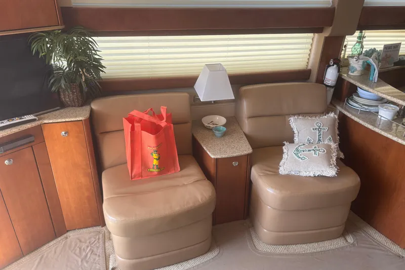 Slide: The Image of Interior of 2007 Meridian 391 Sedan with beige seating, red bag, and nautical-themed pillow. - 3