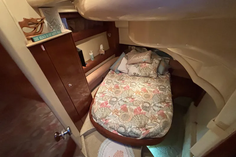 Slide: The Image of Cozy cabin interior of 2007 Meridian 391 Sedan with floral bedding and wooden cabinetry. - 6