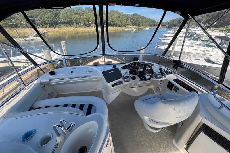 Slide: The Image of 2007 Meridian 391 Sedan yacht cockpit with steering wheel, controls, and scenic marina view. - 8