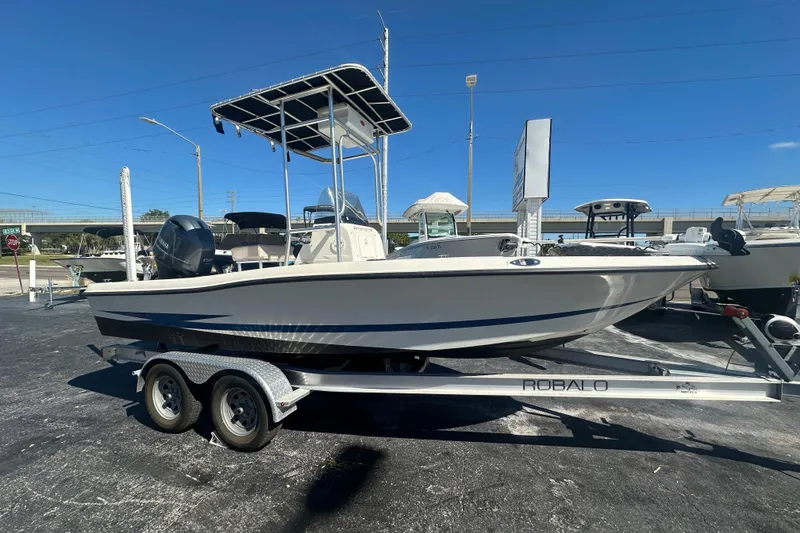The Image of 2003 Hydra-Sports 19 Bay Bolt boat on a Robalo trailer, parked outdoors. - 0
