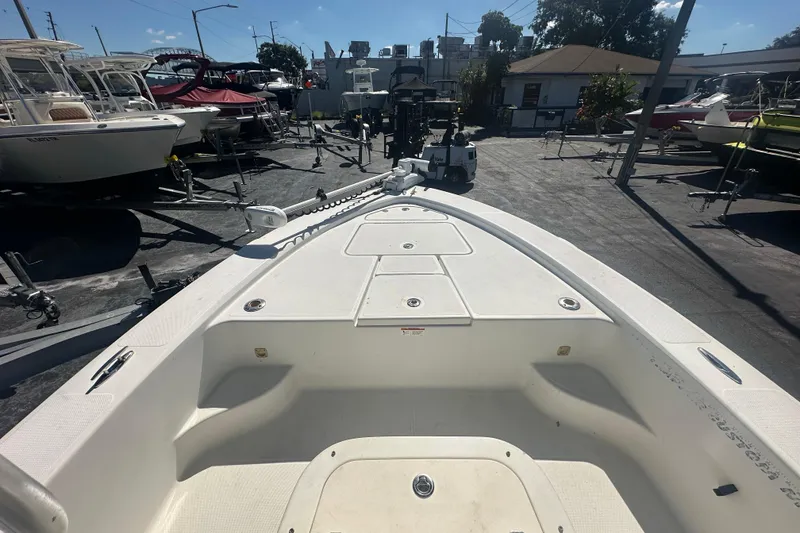 Slide: The Image of 2003 Hydra-Sports 19 Bay Bolt boat, white deck, parked in a marina with other boats. - 11
