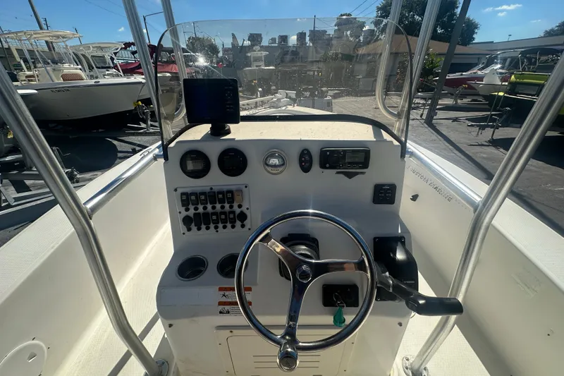 Slide: The Image of 2003 Hydra-Sports 19 Bay Bolt boat dashboard with steering wheel and controls. - 18