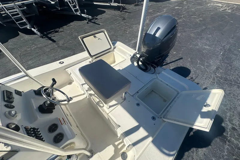 Slide: The Image of 2003 Hydra-Sports 19 Bay Bolt boat interior with open storage compartments and outboard motor. - 21