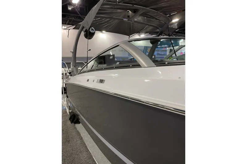 Slide: The Image of 2026 Four Winns H6 OB boat displayed indoors, showcasing sleek design and modern features. - 16