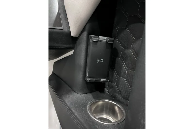 Slide: The Image of 2026 Four Winns H6 OB interior with wireless charging pad and cup holder. - 30
