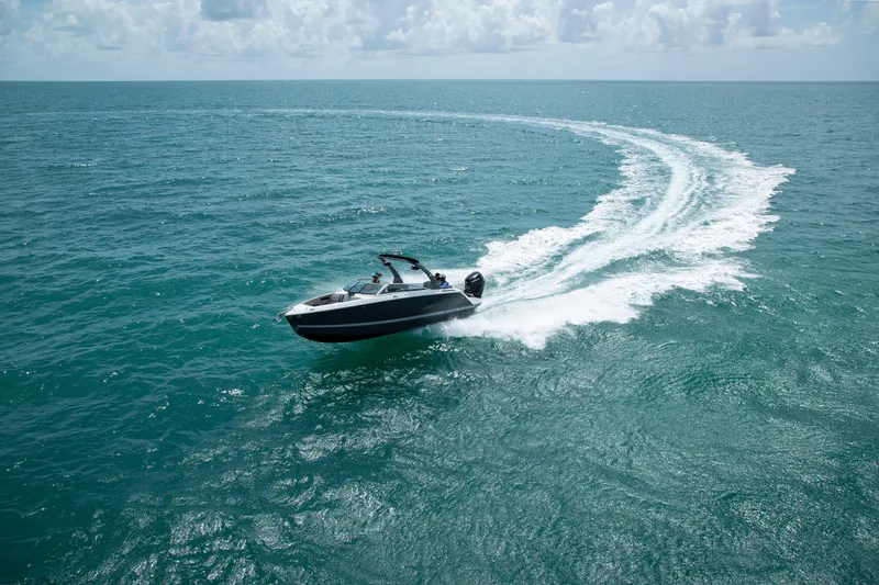 Slide: The Image of 2026 Four Winns H6 OB boat cruising on open ocean waters. - 6