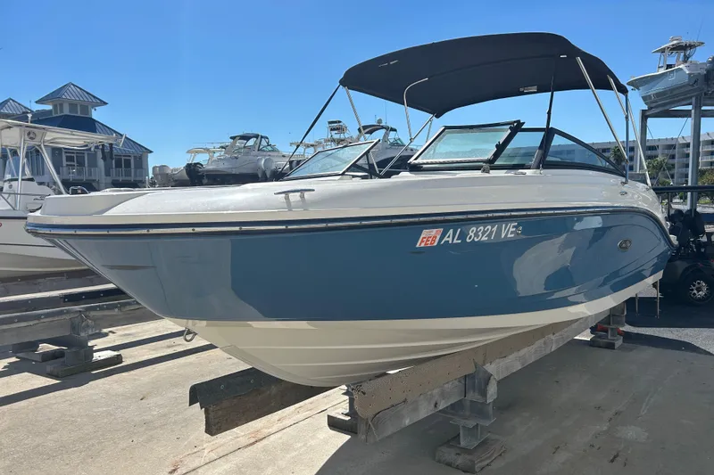 The Image of 2020 Sea Ray SPX 230 Outboard boat on a dock under clear blue sky. - 1