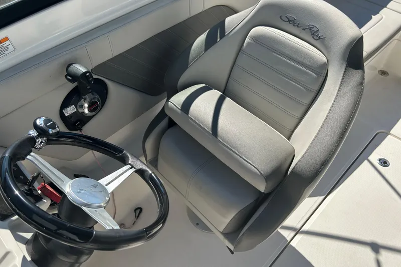 Slide: The Image of 2020 Sea Ray SPX 230 Outboard cockpit with steering wheel and comfortable seating. - 11