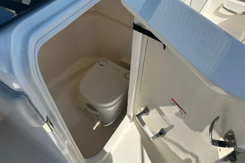 Slide: The Image of 2020 Sea Ray SPX 230 Outboard boat interior with compact marine toilet. - 14