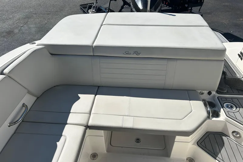 Slide: The Image of 2020 Sea Ray SPX 230 Outboard boat interior with white cushioned seating. - 16