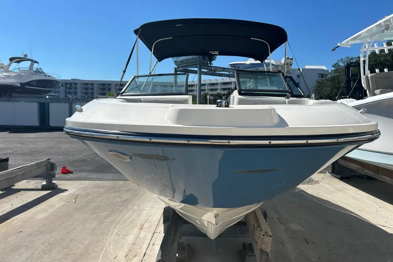 Slide: The Image of 2020 Sea Ray SPX 230 Outboard boat on trailer, marina background, sunny day. - 2