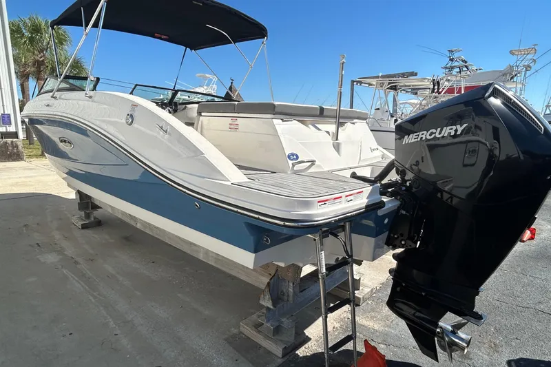 Slide: The Image of 2020 Sea Ray SPX 230 Outboard boat with Mercury engine, docked under clear blue sky. - 6