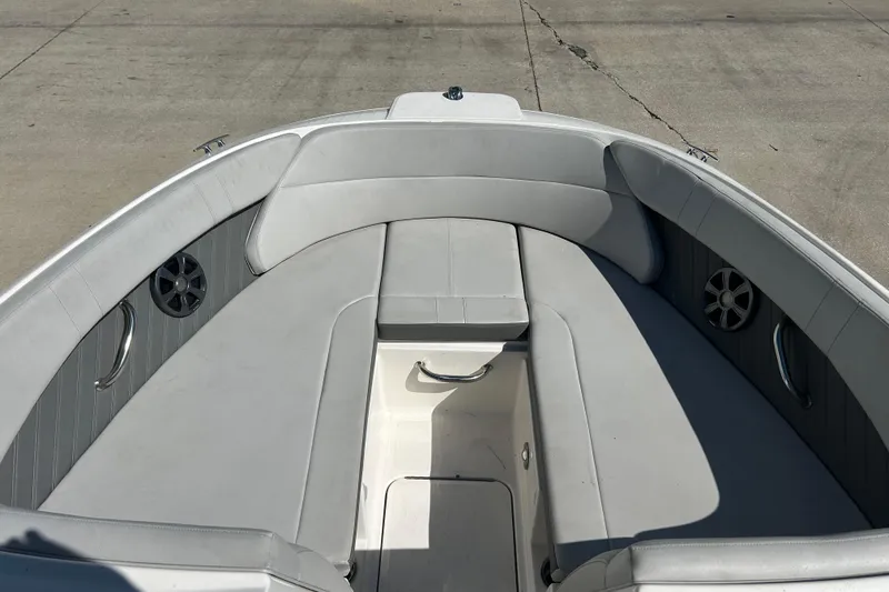 Slide: The Image of 2020 Sea Ray SPX 230 Outboard boat interior with gray seating and speakers. - 7