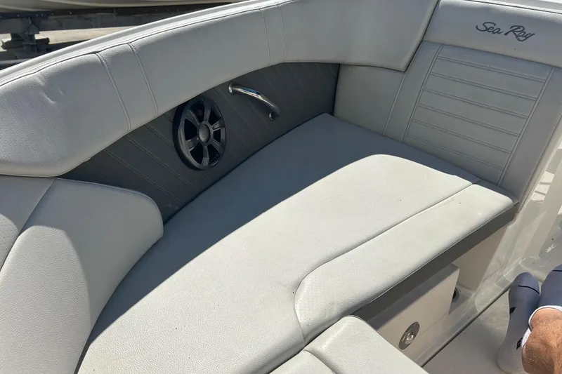 Slide: The Image of 2020 Sea Ray SPX 230 Outboard boat interior with cushioned seating and speaker. - 8