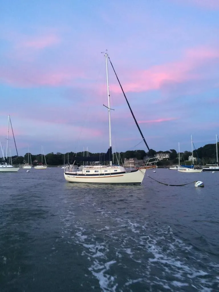Slide: The Image of Pacific Seacraft Dana 24 sailboat anchored at sunset, 2003 model. - 2