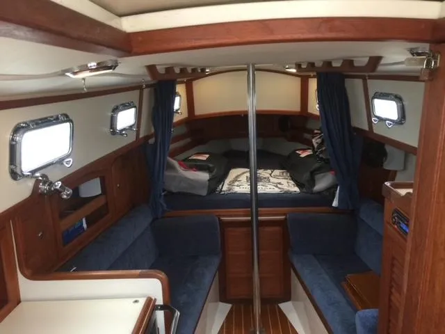 Slide: The Image of Interior of 2003 Pacific Seacraft Dana 24 sailboat with cozy seating and wooden finishes. - 3