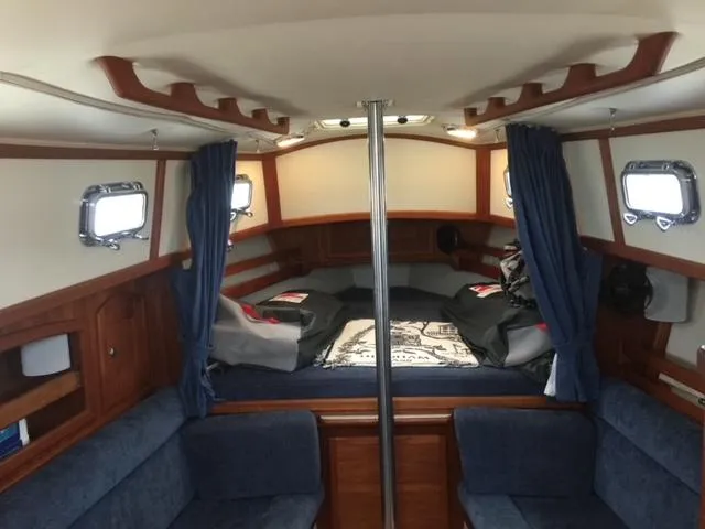 Slide: The Image of Interior of 2003 Pacific Seacraft Dana 24 sailboat with cozy cabin and blue upholstery. - 4