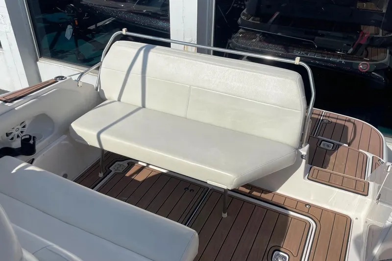 Slide: The Image of 2004 Regal Commodore 2665 boat interior with white seating and wooden deck. - 15
