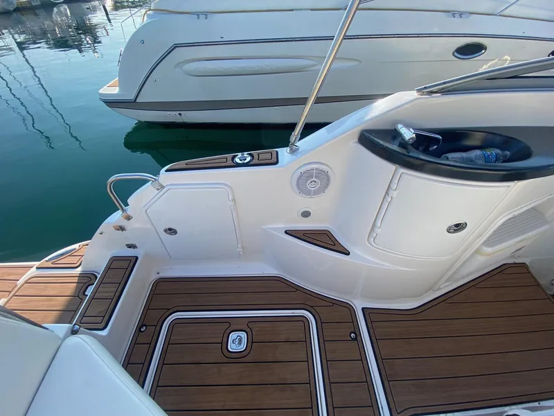Slide: The Image of 2004 Regal 2665 Commodore boat deck with wood flooring and storage compartments. - 16