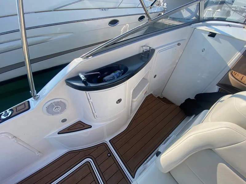 Slide: The Image of 2004 Regal 2665 Commodore boat interior with wood flooring and white seating. - 17