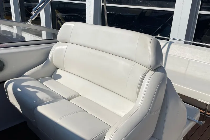 Slide: The Image of White leather seating on 2004 Regal Commodore 2665 boat, with sunlight and window reflections. - 18