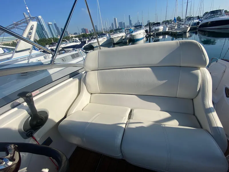 Slide: The Image of 2004 Regal 2665 Commodore boat with white leather seating at a marina. - 19
