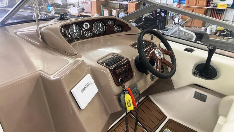 Slide: The Image of 2004 Regal 2665 Commodore boat helm with steering wheel and instrument panel. - 23