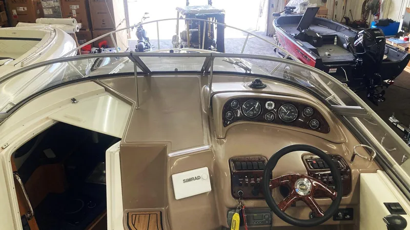 Slide: The Image of 2004 Regal 2665 Commodore boat cockpit with steering wheel and control panel. - 25