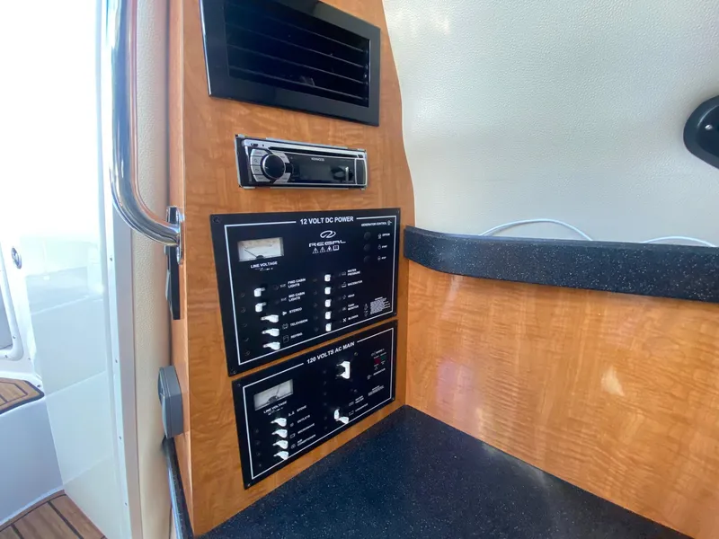 Slide: The Image of Control panel of a 2004 Regal 2665 Commodore boat interior. - 30