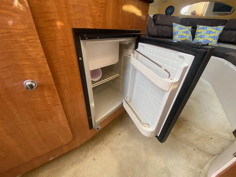 Slide: The Image of Open refrigerator inside 2004 Regal 2665 Commodore boat cabin. - 34