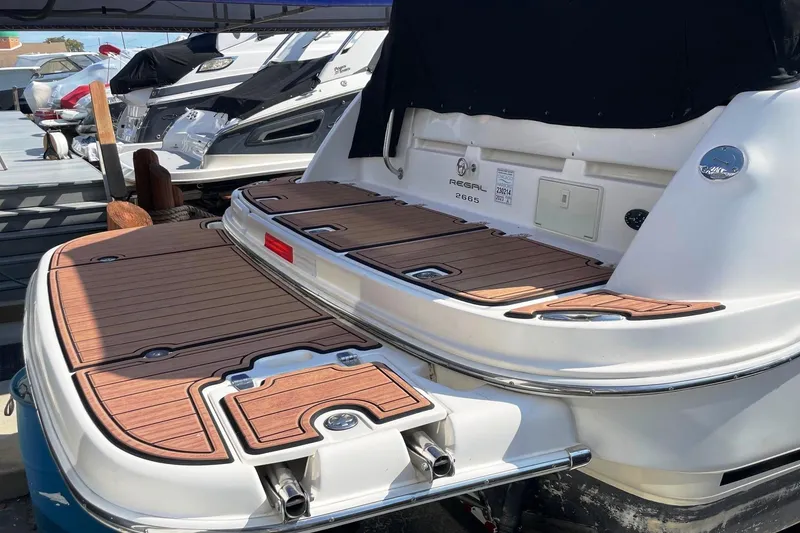 Slide: The Image of 2004 Regal Commodore 2665 boat with wooden deck at marina. - 7