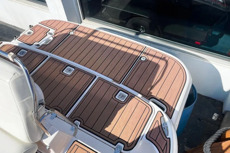 Slide: The Image of 2004 Regal Commodore 2665 boat deck with wood finish and stainless steel railing. - 8