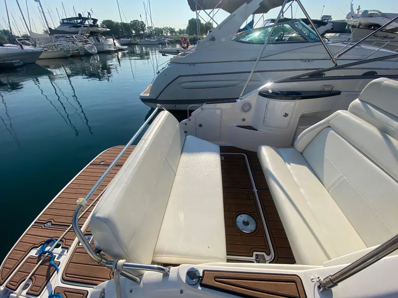 Slide: The Image of 2004 Regal 2665 Commodore boat with white seating at a marina. - 9