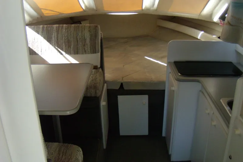 Slide: The Image of 1994 Bayliner 2859 Classic Cruiser interior with dining area and kitchenette. - 10